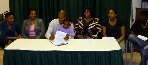 Ramel Alexander signing his national letter of intent with family members.